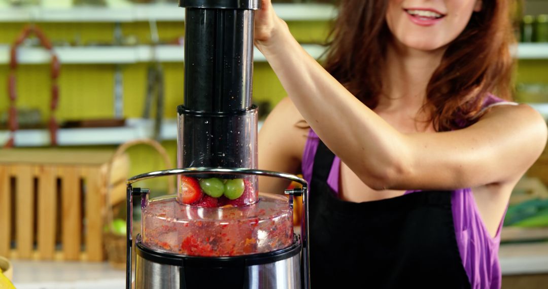 Woman Preparing Fruit Smoothie with Juicer in Kitchen - Free Images, Stock Photos and Pictures on Pikwizard.com