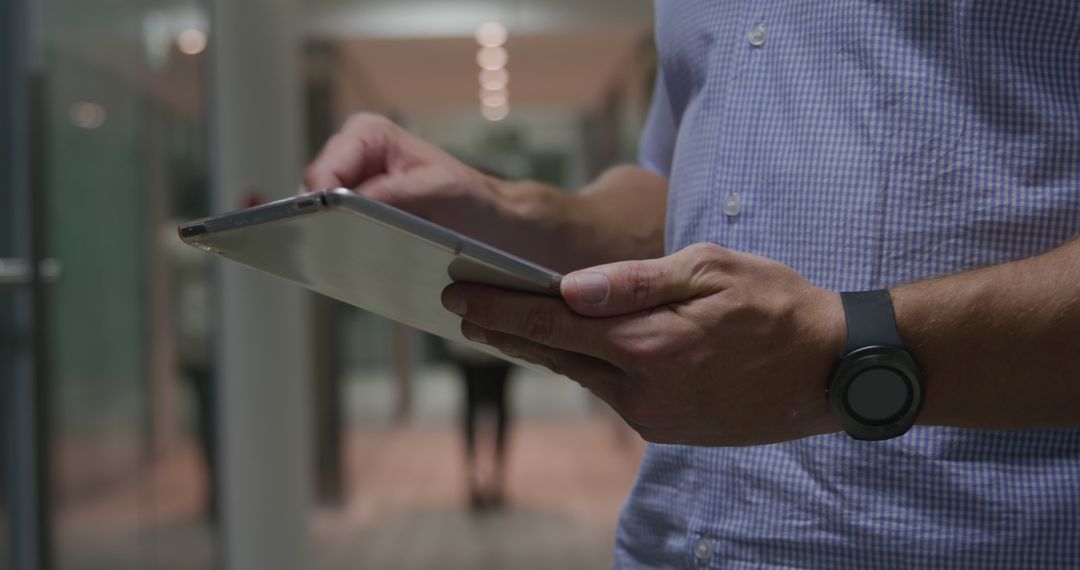 Businessman Multitasking with Tablet in Office Corridor