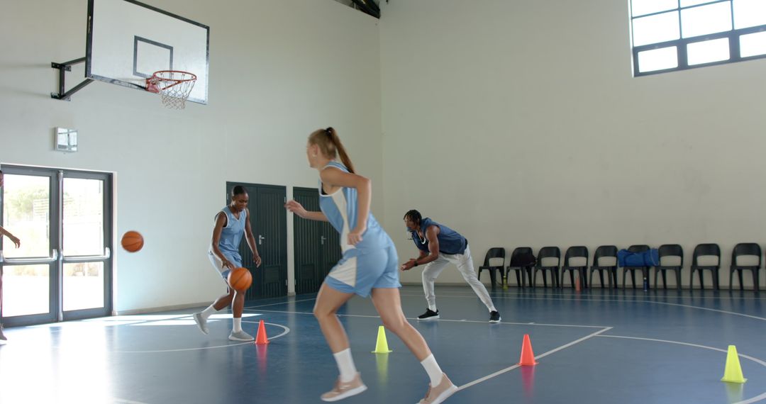 Diverse Teammates Practicing Basketball Dribbling Skills Indoors