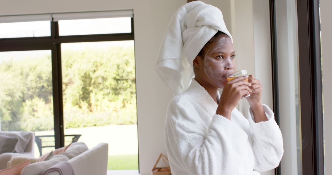 Woman Relaxing at Home in Bathrobe with Face Mask - Free Images, Stock Photos and Pictures on Pikwizard.com