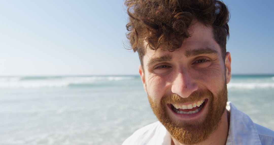 Young Man Smiling Broadly at Beach - Free Images, Stock Photos and Pictures on Pikwizard.com