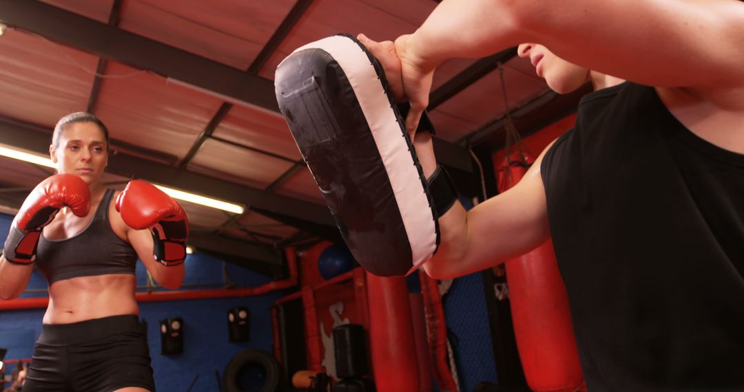 Determined Woman Training Boxing in Gym with Coach - Free Images, Stock Photos and Pictures on Pikwizard.com