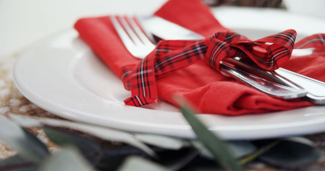 Festive Dining Set with Red Napkin and Plaid Bow for Celebrations - Free Images, Stock Photos and Pictures on Pikwizard.com