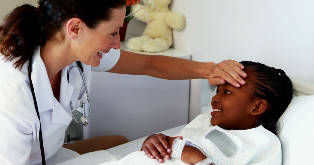 Healthcare Professional Checking Temperature of Smiling Child Patient - Free Images, Stock Photos and Pictures on Pikwizard.com