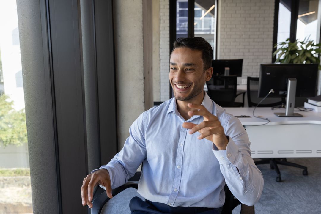 Cheerful Man Engaging in Conversation in Modern Office