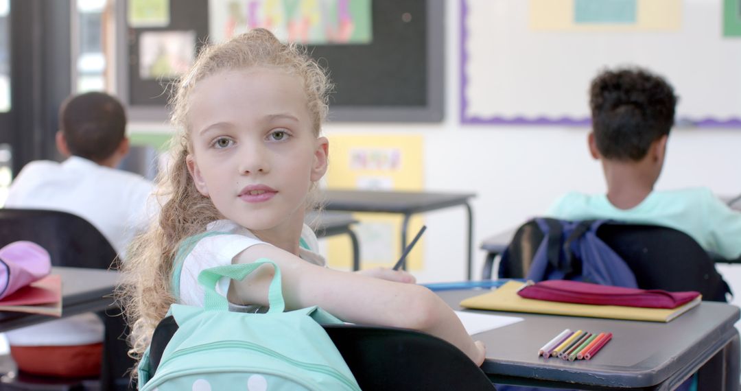 Attentive Caucasian Schoolgirl in Classroom Seated at Desk