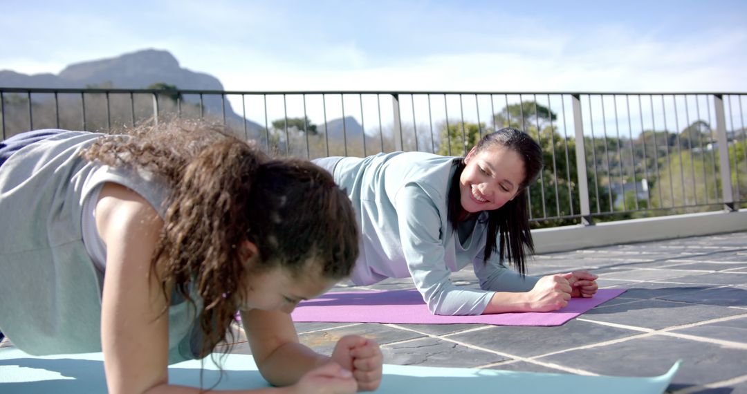 Two Women Practicing Plank Exercise Outdoors with Mountain View - Free Images, Stock Photos and Pictures on Pikwizard.com