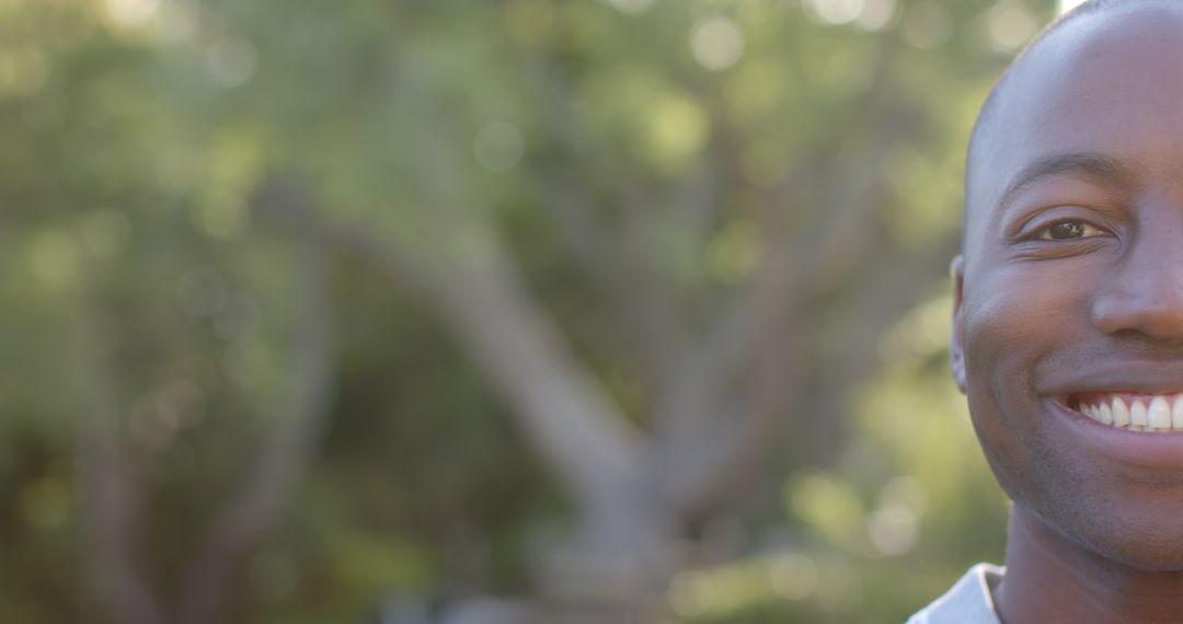 Smiling Man in Nature Embracing Sunshine and Joy