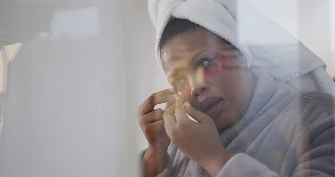 Woman Applying Skincare Treatment with Towel on Head - Free Images, Stock Photos and Pictures on Pikwizard.com