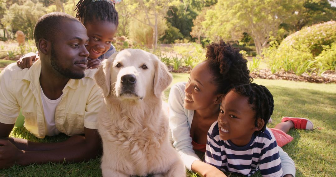 Happy African American Family Relaxing in Park with Golden Retriever - Free Images, Stock Photos and Pictures on Pikwizard.com