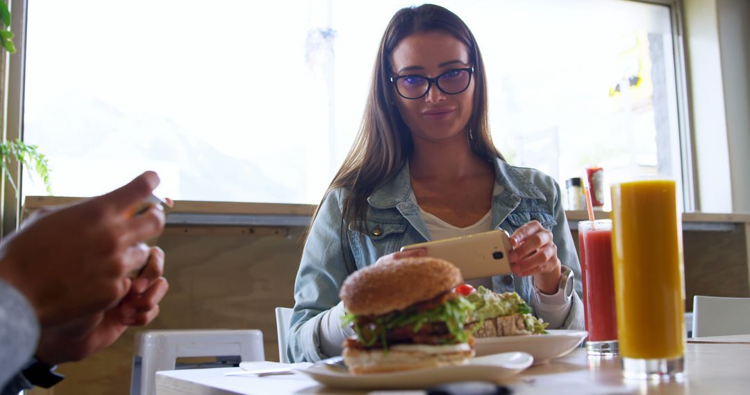 Young Woman Taking Food Photos in Cafe with Smartphone - Free Images, Stock Photos and Pictures on Pikwizard.com