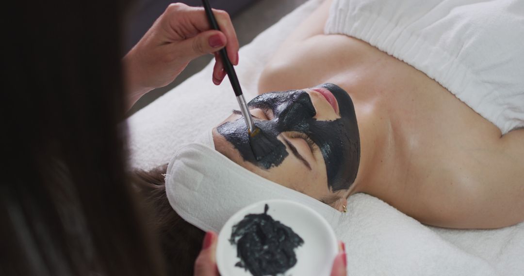 Woman Receiving Black Facial Mask Treatment at Spa - Free Images, Stock Photos and Pictures on Pikwizard.com