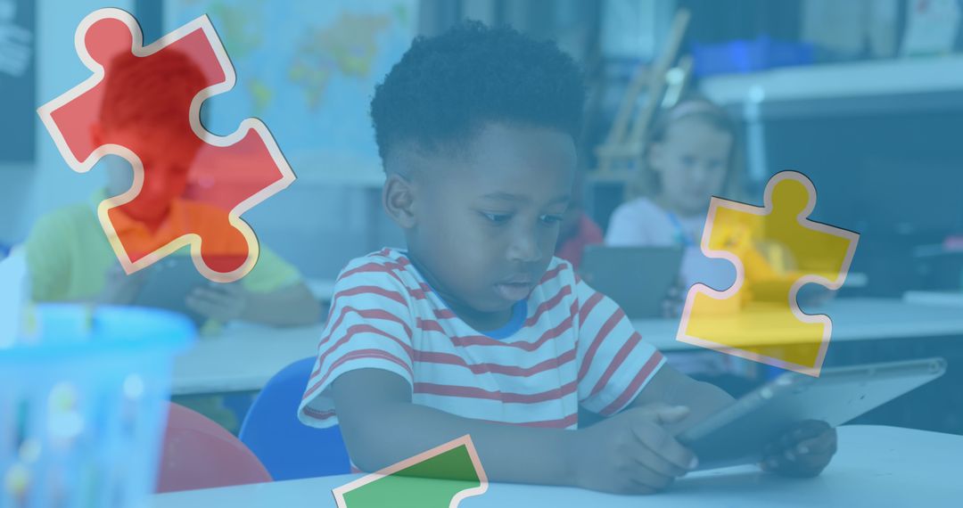 Young African American Boy Using Tablet in Classroom with Puzzle Graphics Overlay - Free Images, Stock Photos and Pictures on Pikwizard.com