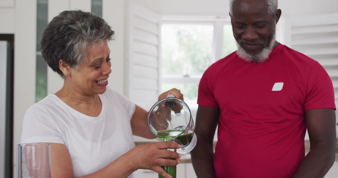 Couple Enjoying Healthy Lifestyle with Smoothie at Home Kitchen
