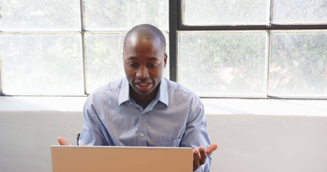 Business Professional Using Laptop at Modern Office Desk by Window