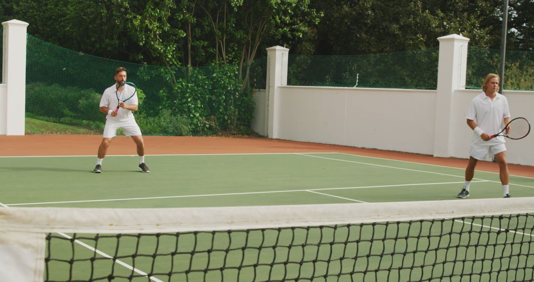 Two Men Playing Tennis Match on Outdoor Court - Free Images, Stock Photos and Pictures on Pikwizard.com