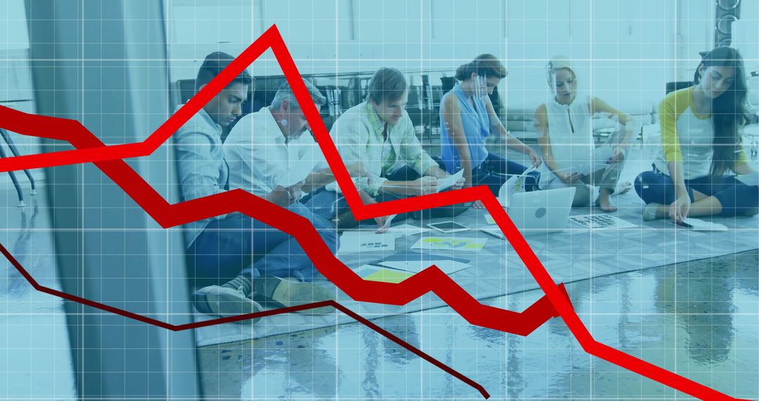 Diverse Team Analyzing Declining Business Graphs in Modern Office