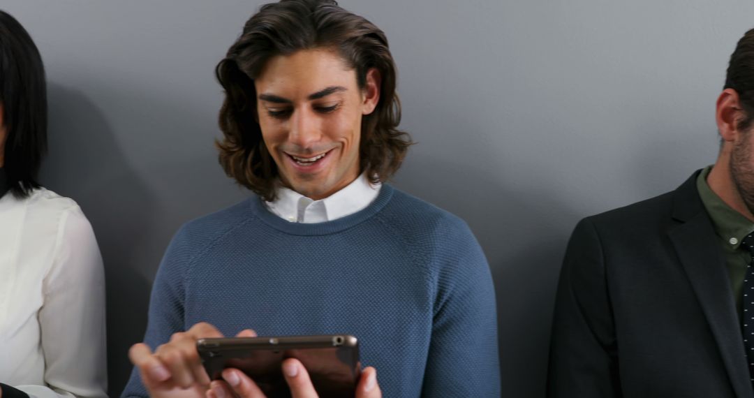 Businessman Smiling and Engaged with Smartphone Screen