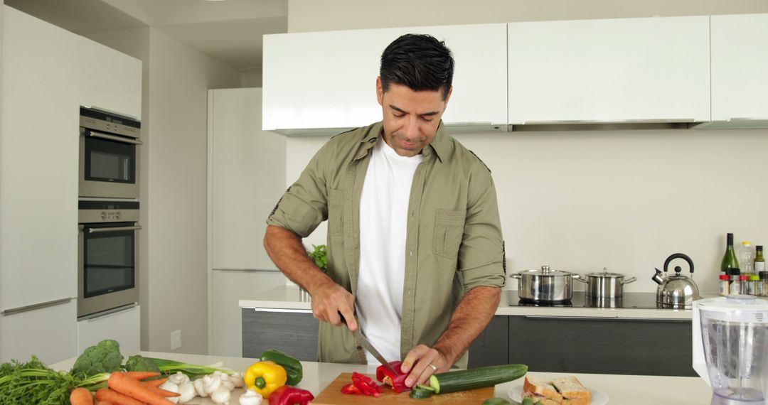 Man Cutting Vegetables in Modern Kitchen - Free Images, Stock Photos and Pictures on Pikwizard.com