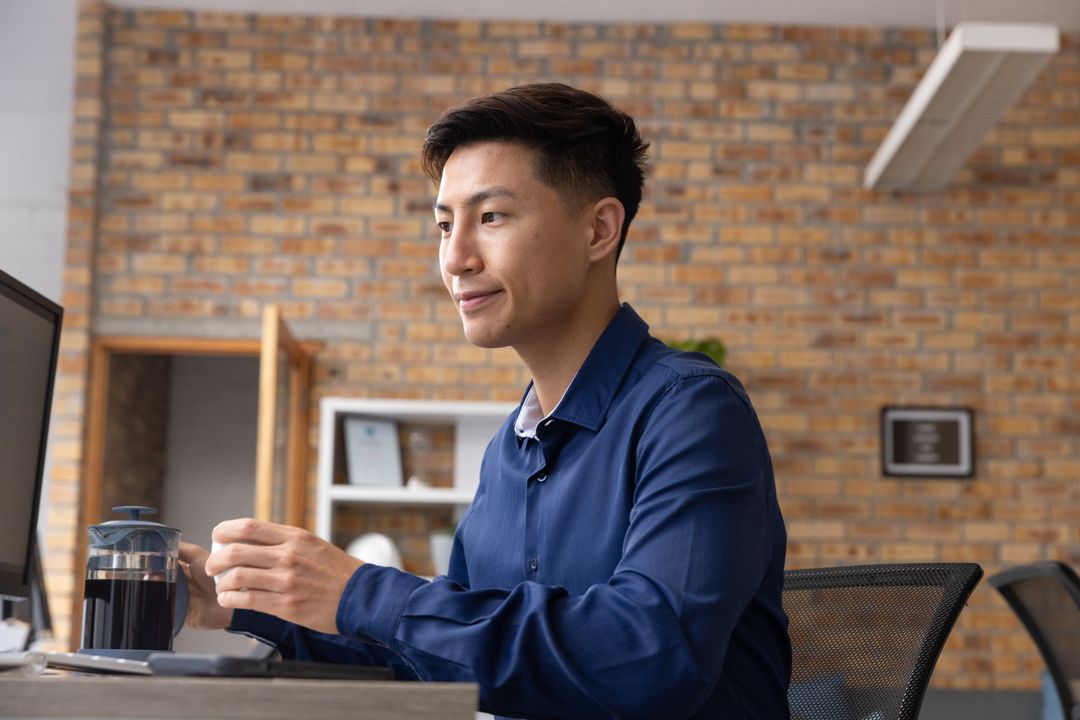 Professional Man Using French Press in Modern Office