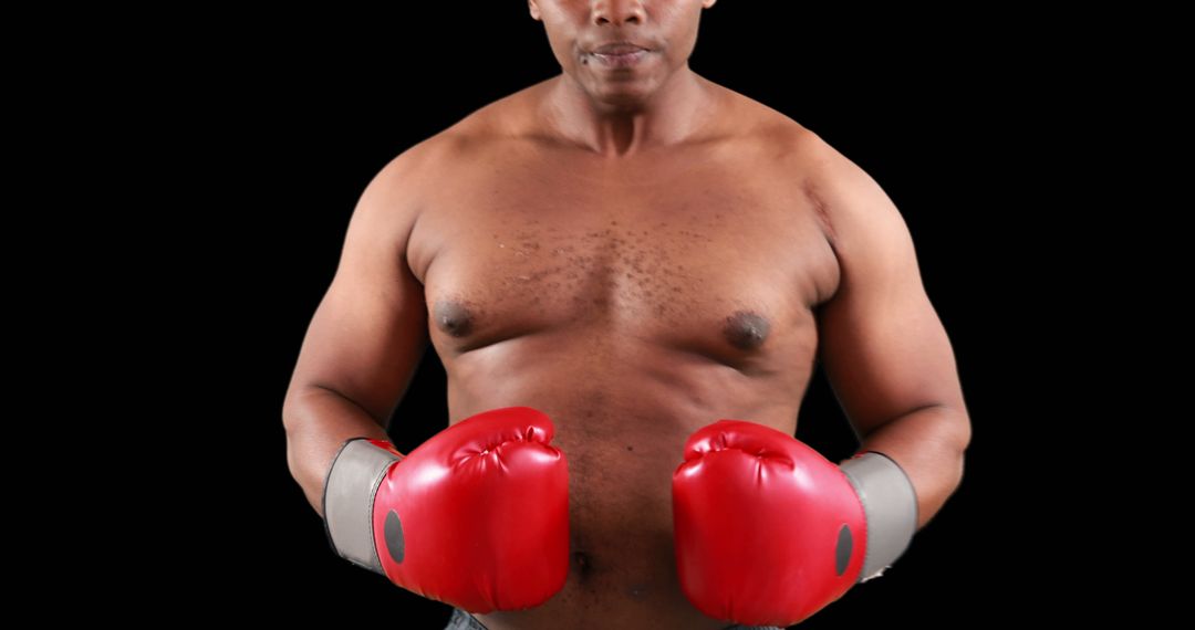 Confident Boxer with Red Gloves in Fighting Stance on Black Background - Free Images, Stock Photos and Pictures on Pikwizard.com