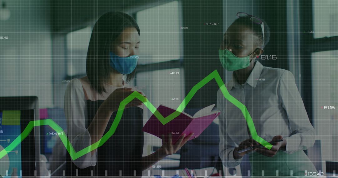 Diverse Businesswomen Analyzing Data with Face Masks in Office