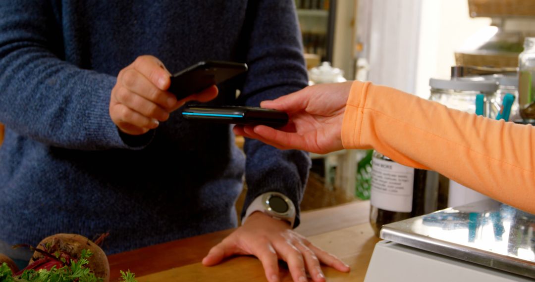 People Engaging in Mobile Payment Transaction at Register - Free Images, Stock Photos and Pictures on Pikwizard.com