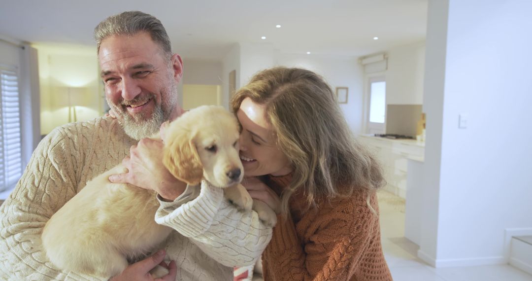 Happy Couple Embracing Golden Retriever Puppy in Cozy Home