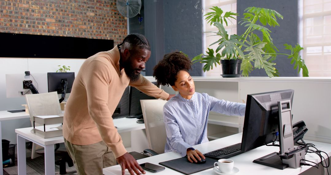 Colleagues Collaborating on Office Computer for Project