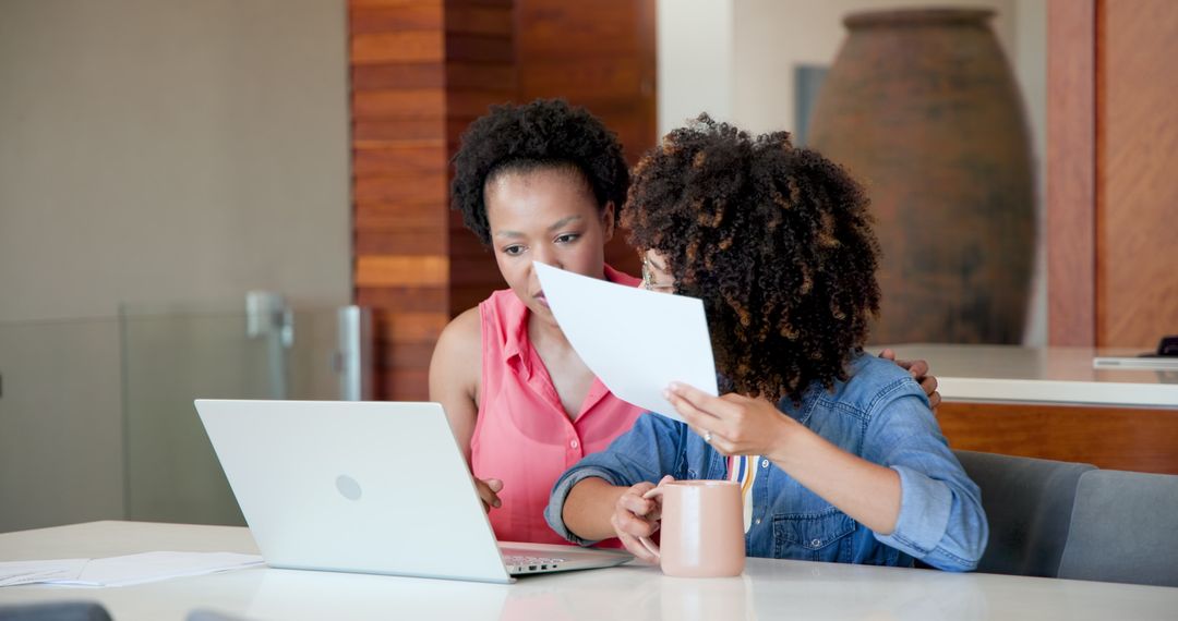 Two Women Collaborating on Laptop at Home
