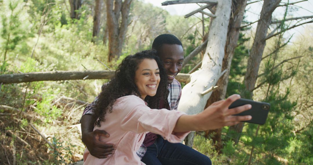 Cheerful Couple Capturing Selfie in Sunny Forest