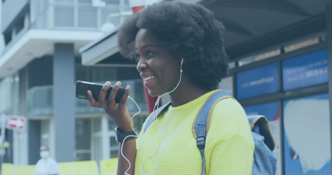 Cheerful Woman Using Voice Technology in Urban Setting