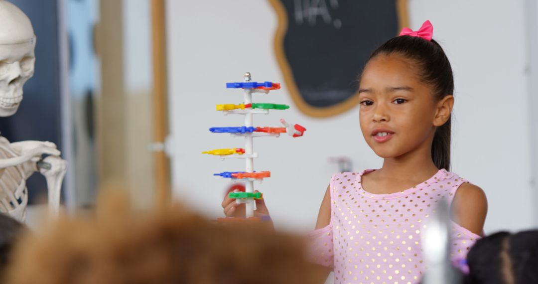 Schoolgirl Explaining DNA Model in Classroom Science Lesson