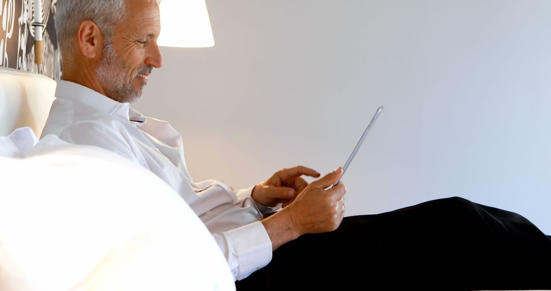 Businessman Using Tablet for Remote Work at Home