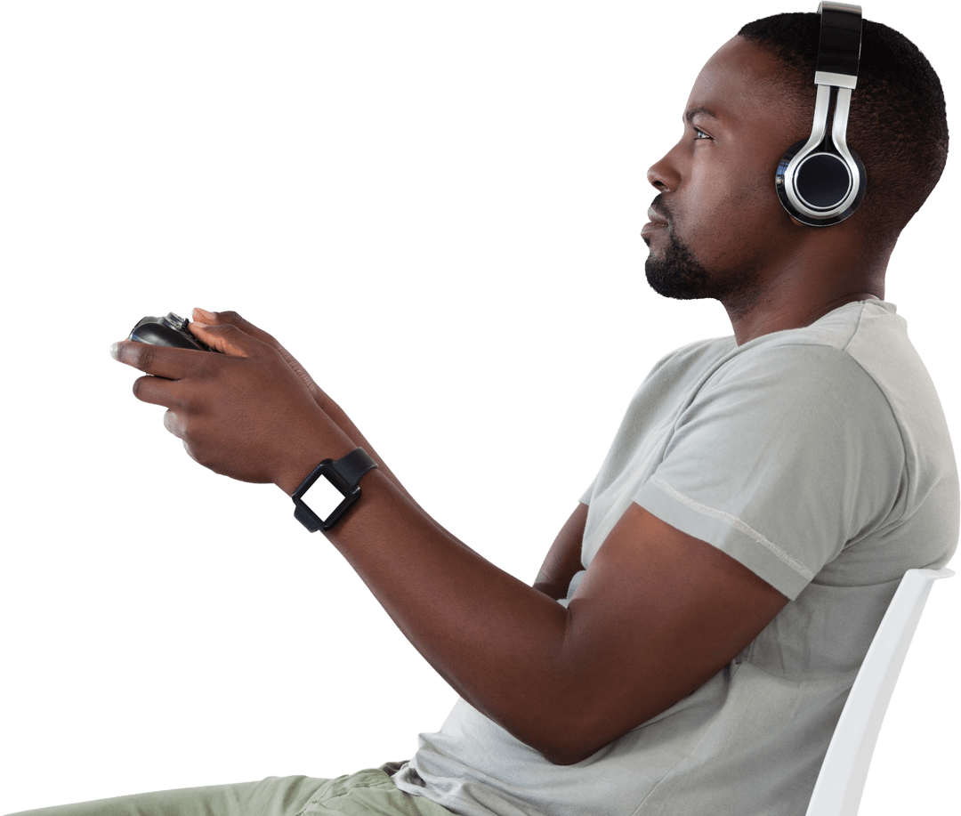 Gamer Sitting Indoors Playing Video Games With Controller, Headphones