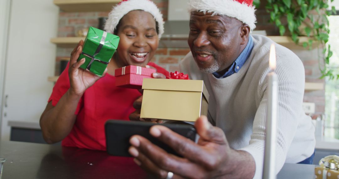 Senior African American Couple Showing Christmas Gift on Video Call - Free Images, Stock Photos and Pictures on Pikwizard.com