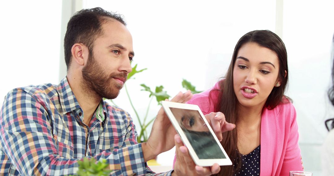 Diverse Business Colleagues Collaborating with Tablet in Office