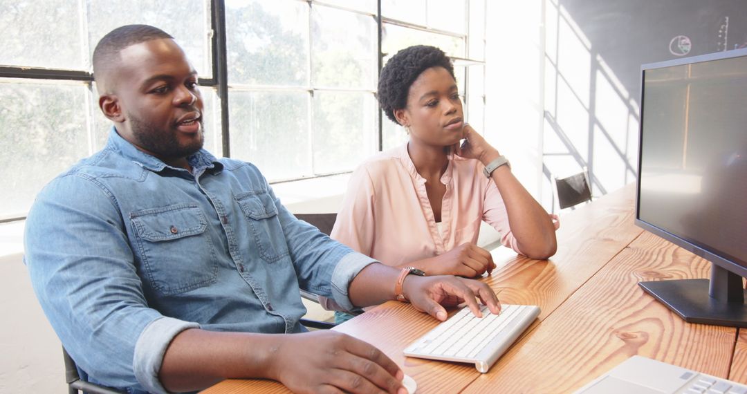 Business Professionals Collaborating on Project at Office Desk