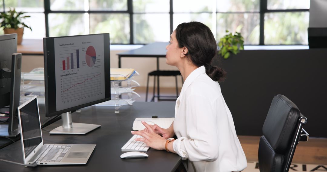 Focused Businesswoman Analyzing Data on Computer in Modern Office