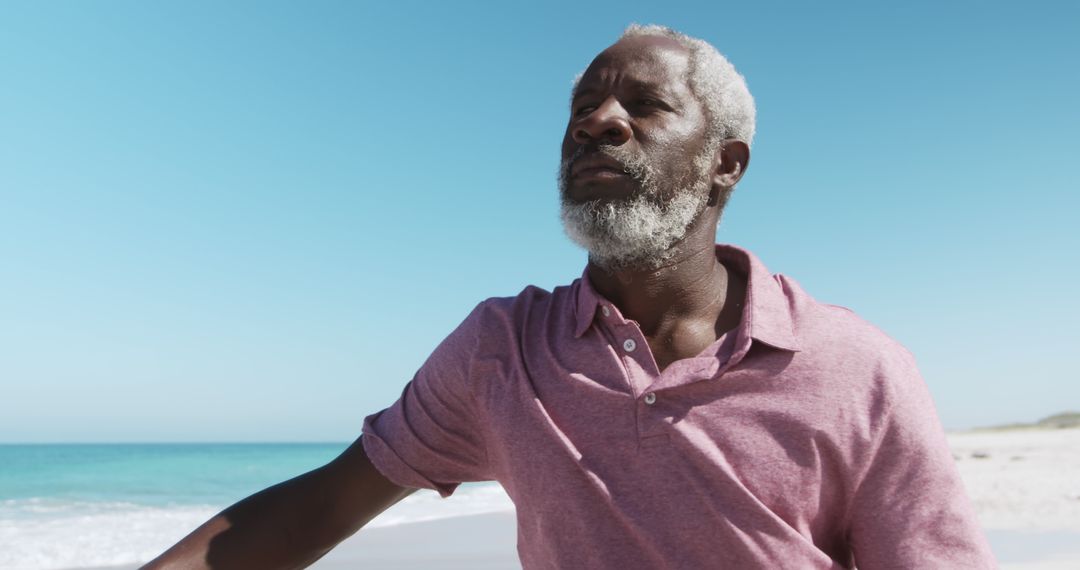 Senior Man Relaxing on Beach Under Clear Blue Sky - Free Images, Stock Photos and Pictures on Pikwizard.com