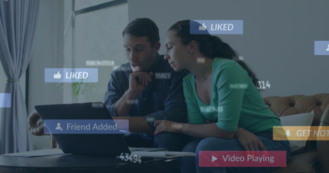 Couple Browsing Laptop with Social Media Icons Indoors