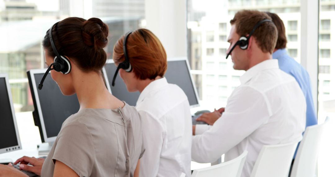 Customer Service Representatives Working in Office with Headsets - Free Images, Stock Photos and Pictures on Pikwizard.com