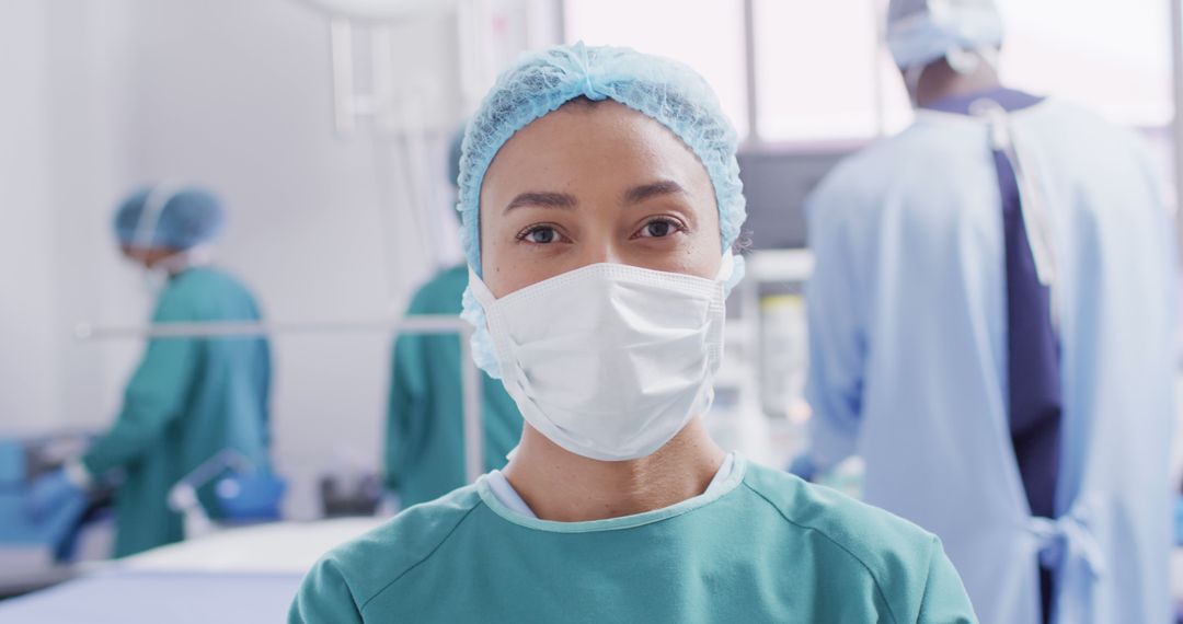 Female Surgeon Wearing Mask in Operating Room with Medical Team - Free Images, Stock Photos and Pictures on Pikwizard.com