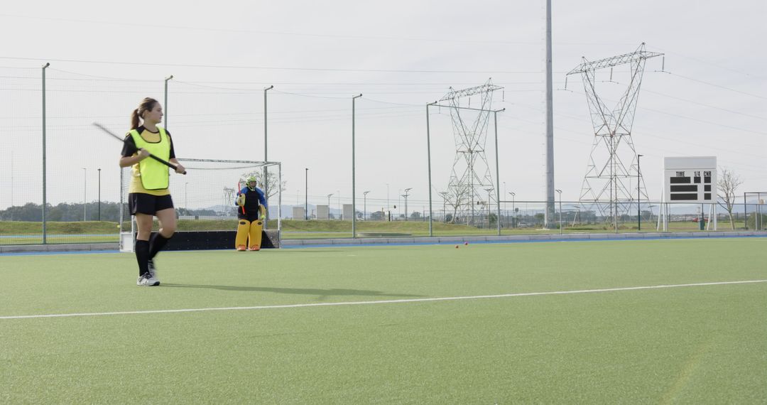 Female Hockey Players on Synthetic Turf Field Preparing for Practice