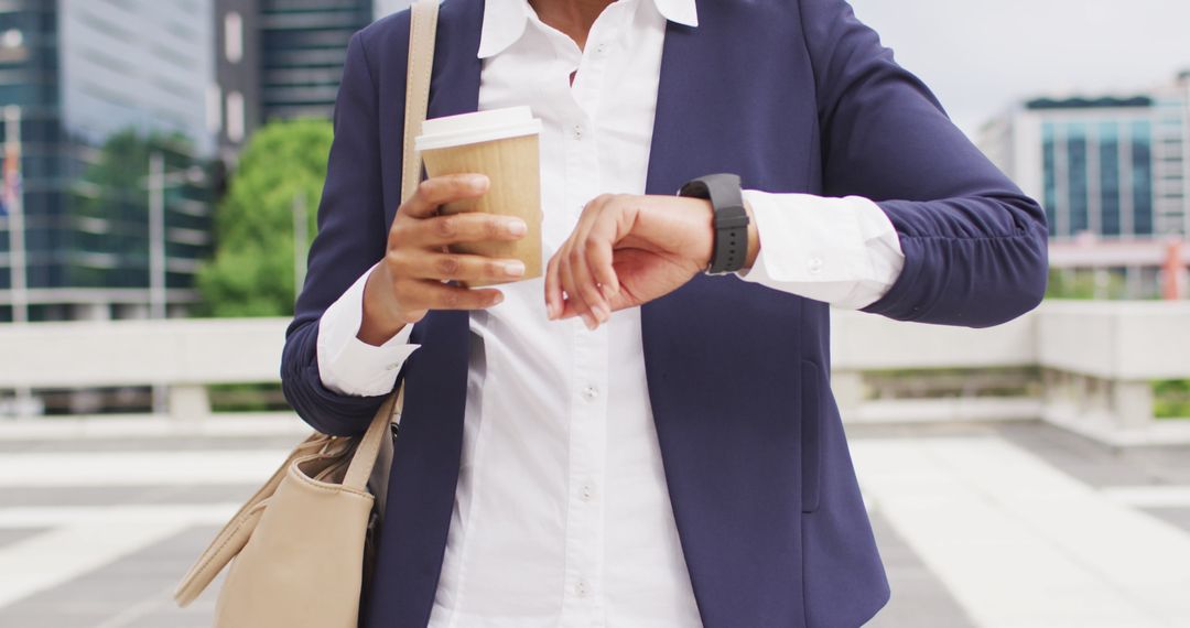 Businesswoman Checking Smartwatch While Commuting with Coffee