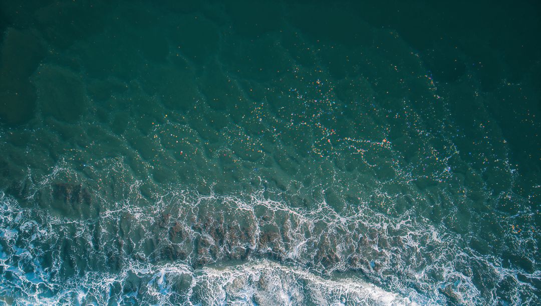 Sunlight Sparkling Over Breaking Surf Crashing Over Sandbar Aerial Ocean Waves Coastal