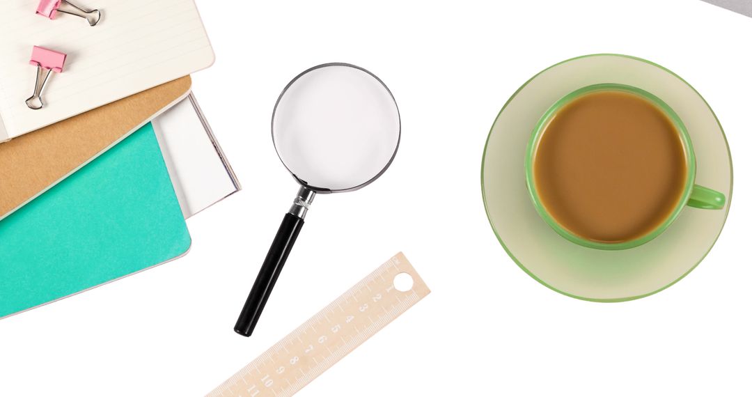 Minimal Workspace with Coffee, Magnifying Glass, Notebooks and Ruler