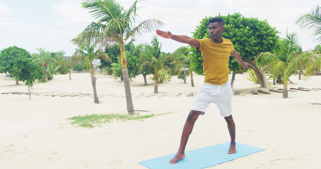 Man Practicing Yoga on Beach Surrounded by Palm Trees - Free Images, Stock Photos and Pictures on Pikwizard.com