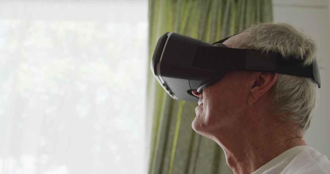Senior Man Engaged with Virtual Reality Technology at Home