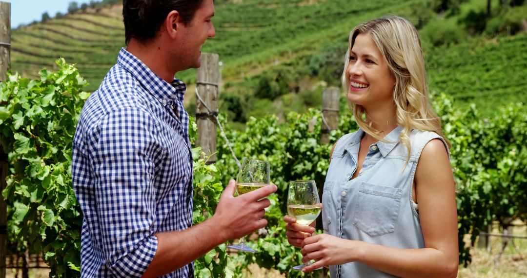 Happy Couple Enjoying Wine in Vineyard on Sunny Day